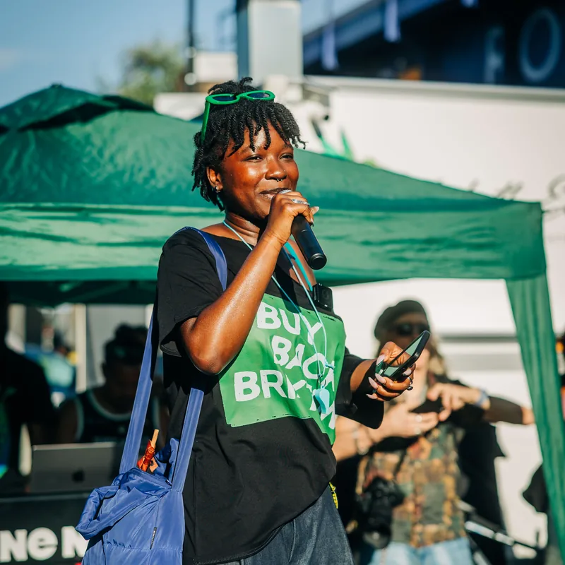 A supporter in a Buy Back Brixton T-shirt in the thick of the crowd.